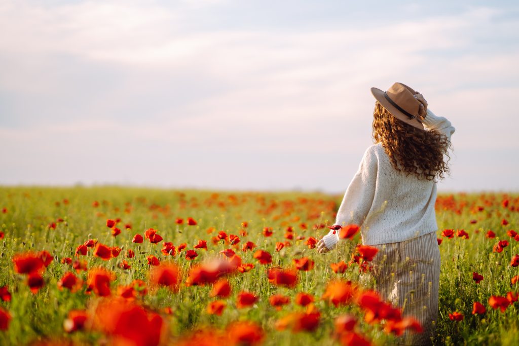 Woman in a field of red flowers